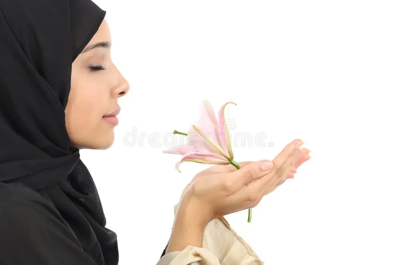 hijabi smelling flower